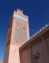 Low angle view of clock tower against blue sky