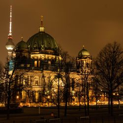 Illuminated church in city against sky at night