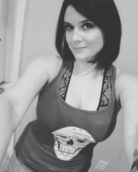 Portrait of a smiling young woman standing at home
