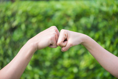 Cropped hands giving fist bump