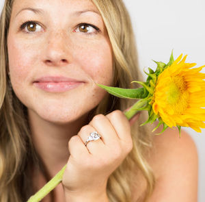 Close-up portrait of a woman holding flower