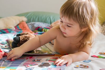 Portrait of little gurl paying with toys at home. 