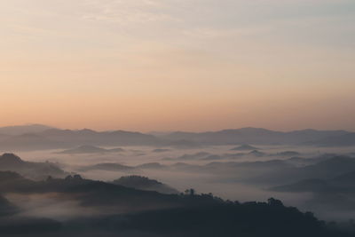 Scenic view of silhouette mountains against sky during sunset