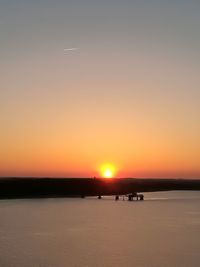 Scenic view of sea against clear sky during sunset