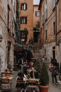 People in front of buildings in city