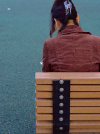 High angle view of woman sitting on park bench