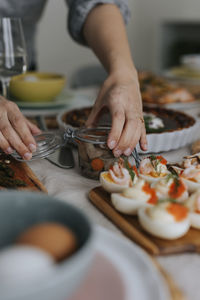 Person opening jar with herrings for easter meal