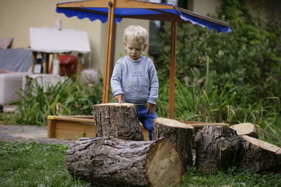 Portrait of woman sitting on log