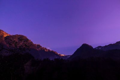 Silhouette mountains against blue sky at sunset