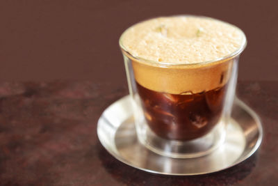 Close-up of coffee in glass on table