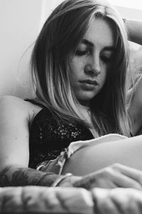 Portrait of beautiful woman relaxing on bed at home