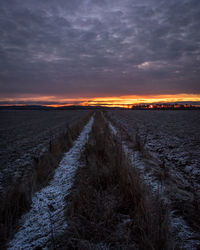 Scenic view of land against sky during sunset