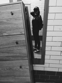 Full length of woman standing by railing