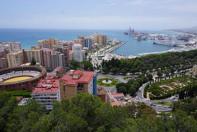High angle view of buildings by sea against sky