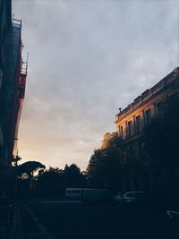 Car in city against dramatic sky