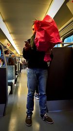 Full length of man standing in bus