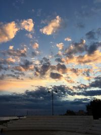 Low angle view of beach against sky during sunset