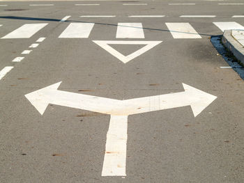 Close-up of arrow symbol on road