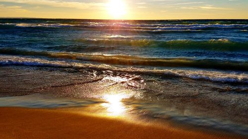 Scenic view of beach against sky during sunset