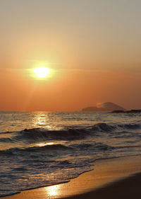 View of calm beach at sunset