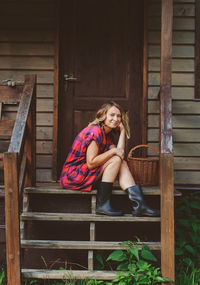 Woman sitting on wooden seat