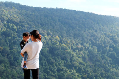 Rear view of couple looking at mountain landscape