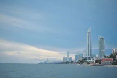 Sea and buildings against sky