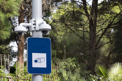 Information sign against trees