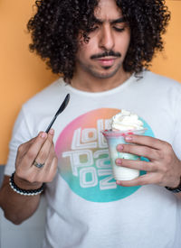 Portrait of young man holding ice cream