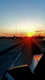 Car on road at sunset