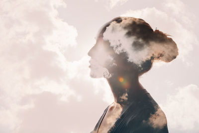 Digital composite of woman looking away against sky