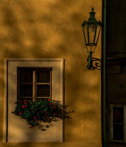 Low angle view of illuminated street light against building