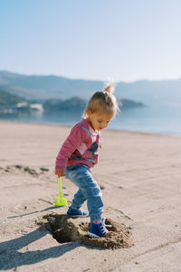 Side view of boy standing at beach