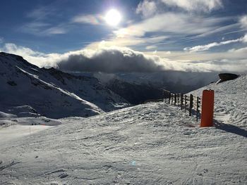 Scenic view of snow covered mountains against sky