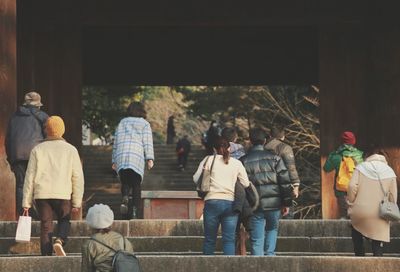 People standing by sculpture