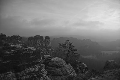 Rock formations on landscape against sky