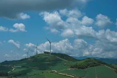 Windmill on field against sky