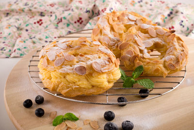 Almond donuts on cooking rack by blueberries