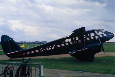 Airplane on airport runway against sky