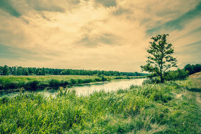 Scenic view of lake against cloudy sky