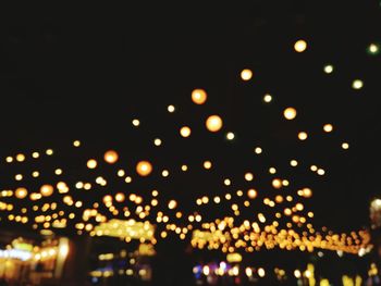 Low angle view of illuminated lights at night