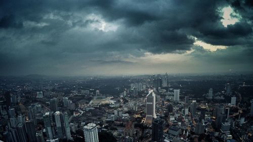 Cityscape against cloudy sky