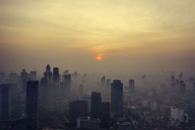 Cityscape against sky during sunset