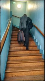 Rear view of couple walking on stairs