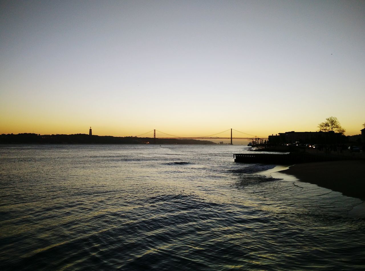 VIEW OF SUSPENSION BRIDGE OVER RIVER