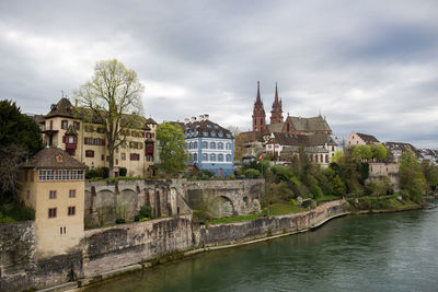 Buildings in city against cloudy sky