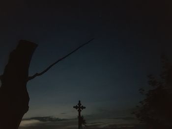 Low angle view of silhouette statue against sky at night