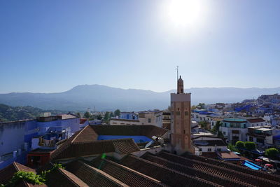 High angle view of houses in town against clear sky