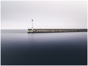 Scenic view of pier at sea against clear sky