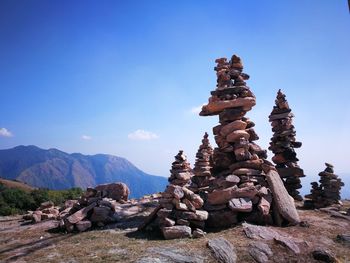 View of stacks of rocks against blue sky